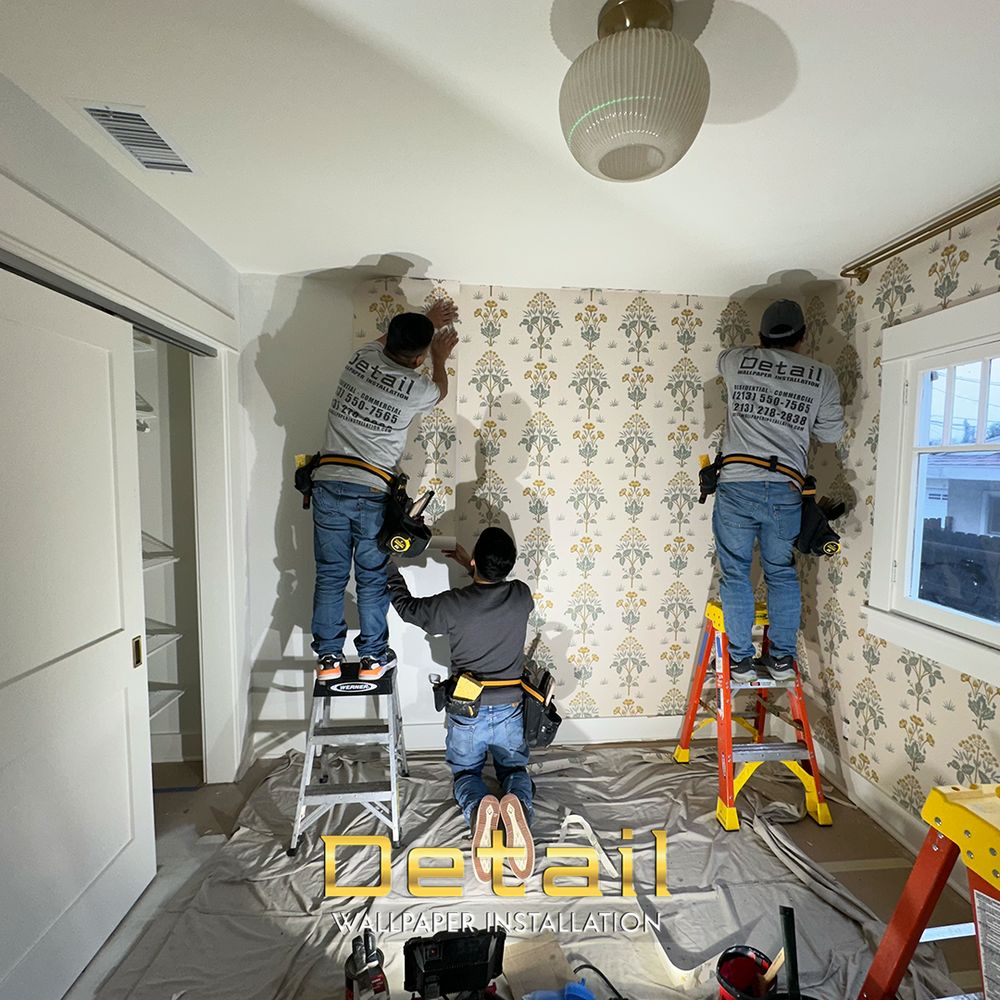 Wallpaper installer working carefully with wallcovering material